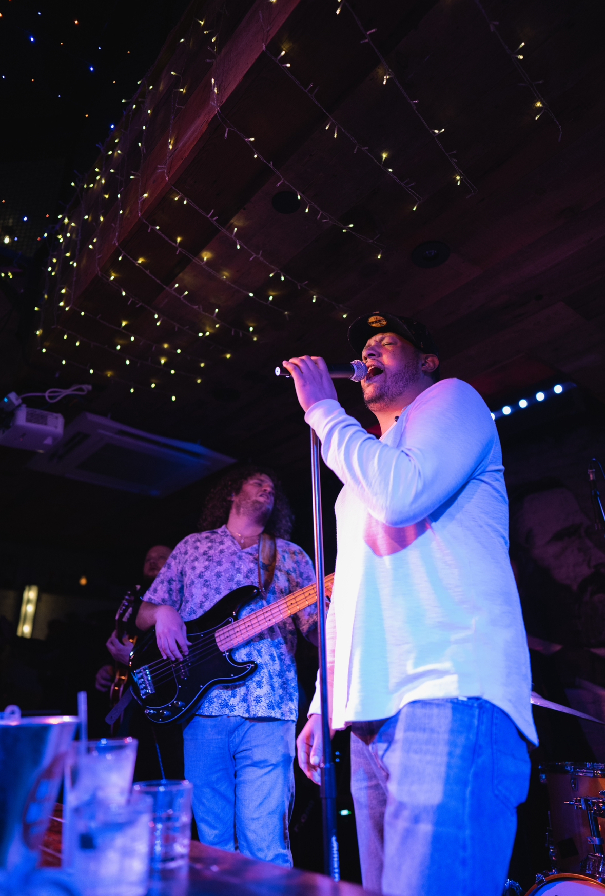 a man standing on a stage playing instruments