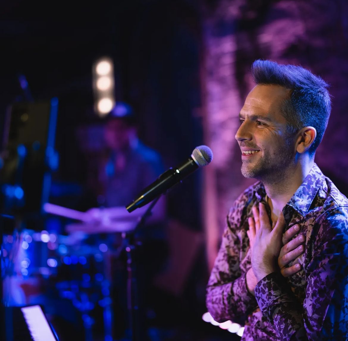 a man talking on a stage