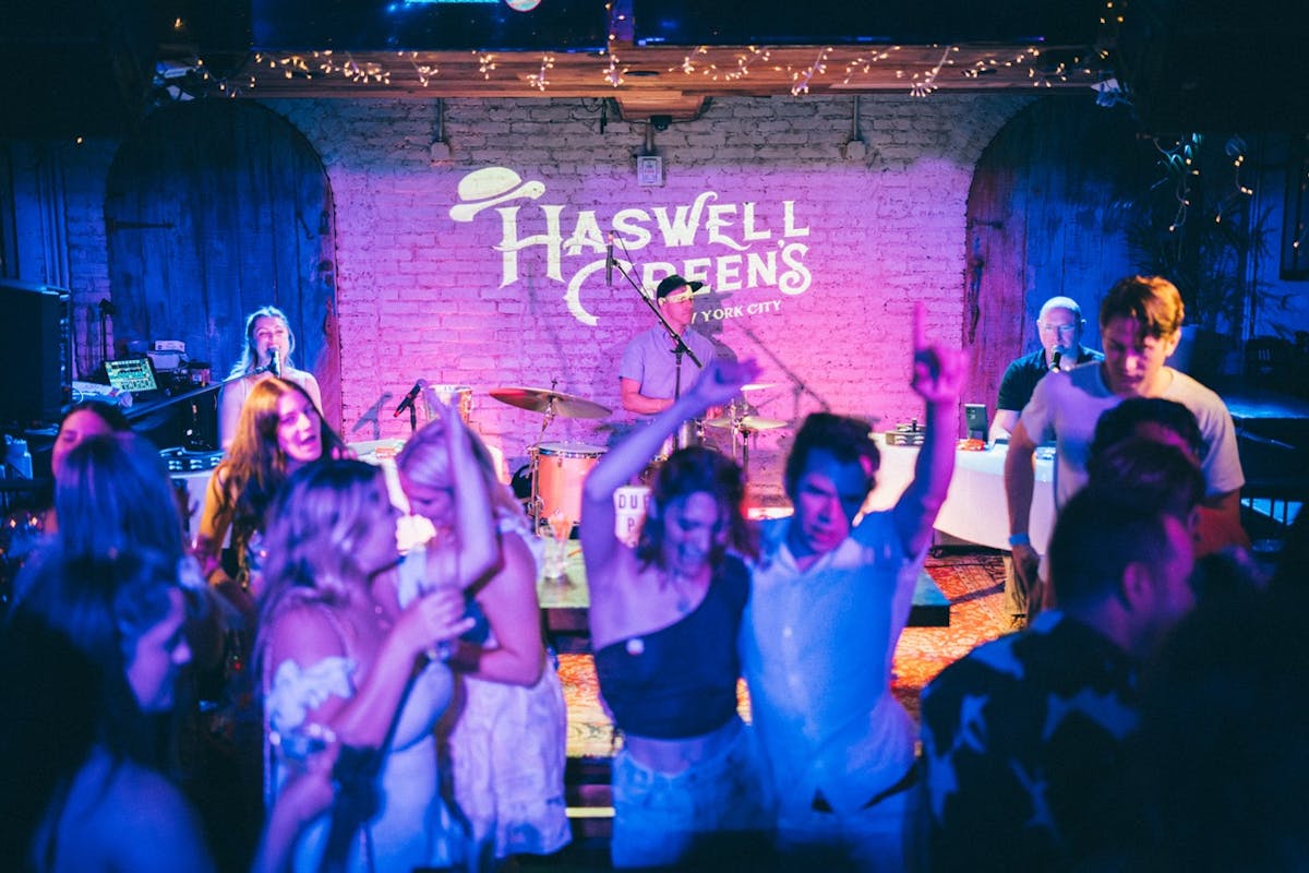 a group of people standing in front of a stage