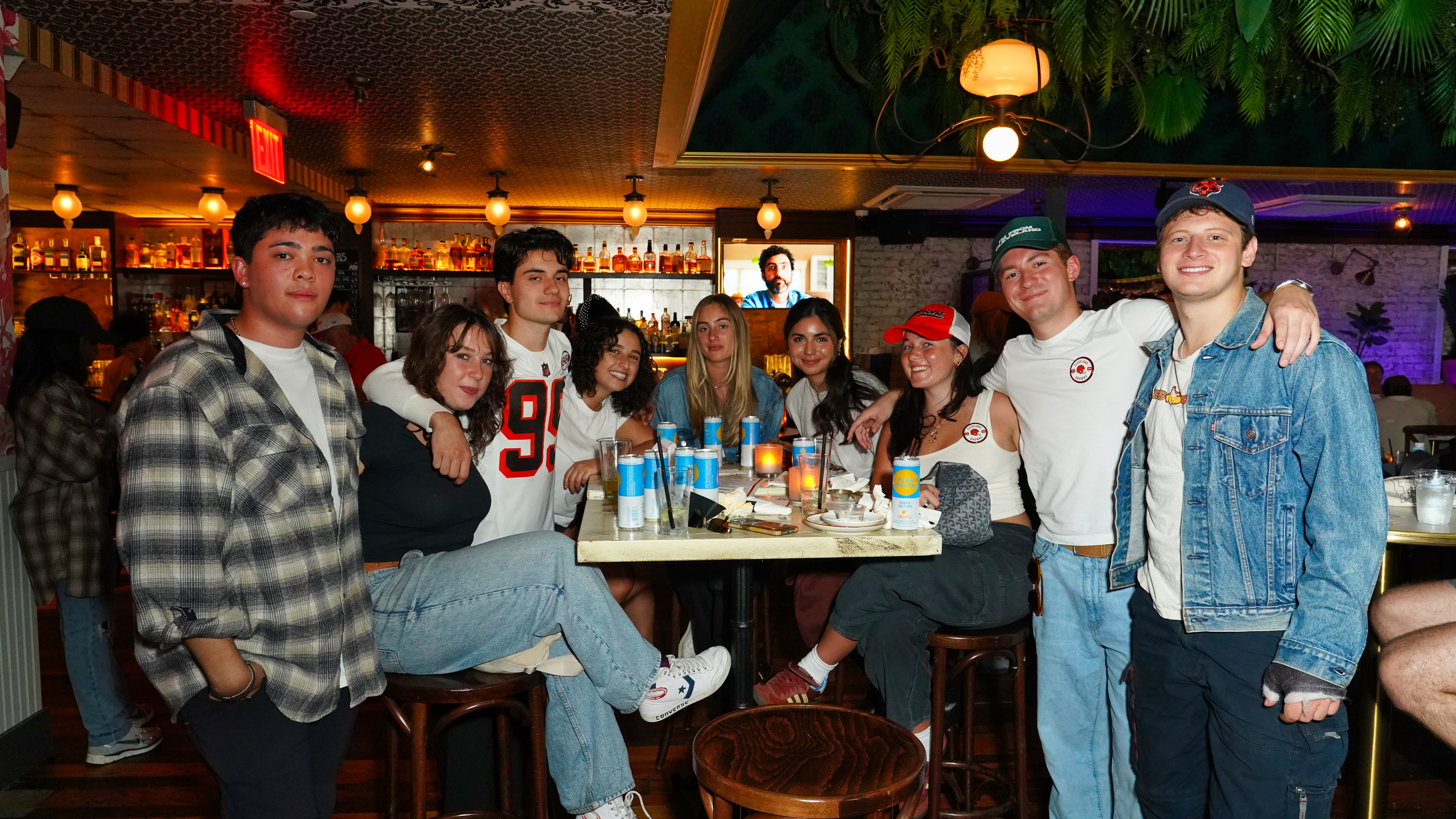 a group of people standing around a table