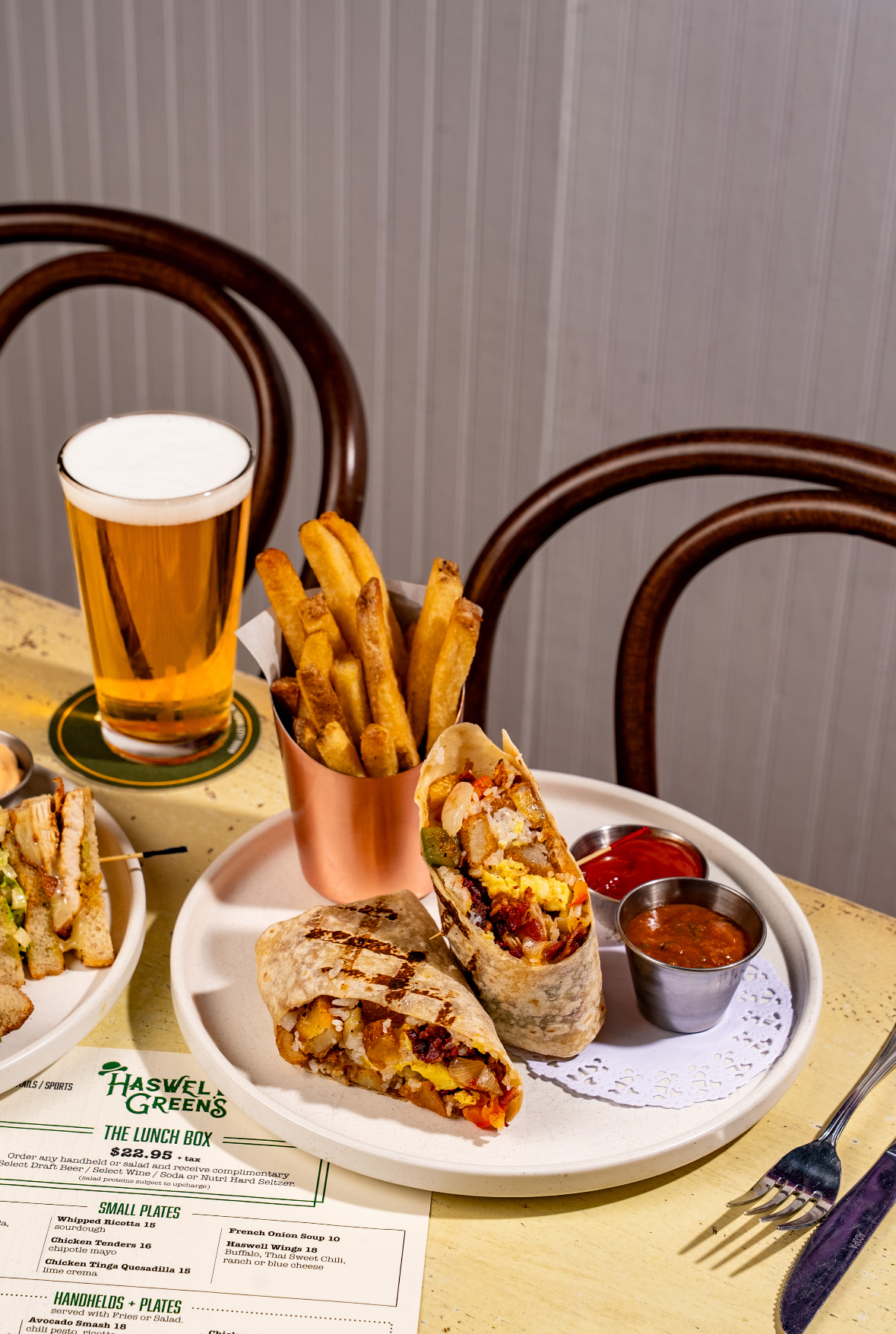 a plate of food and a glass of beer
