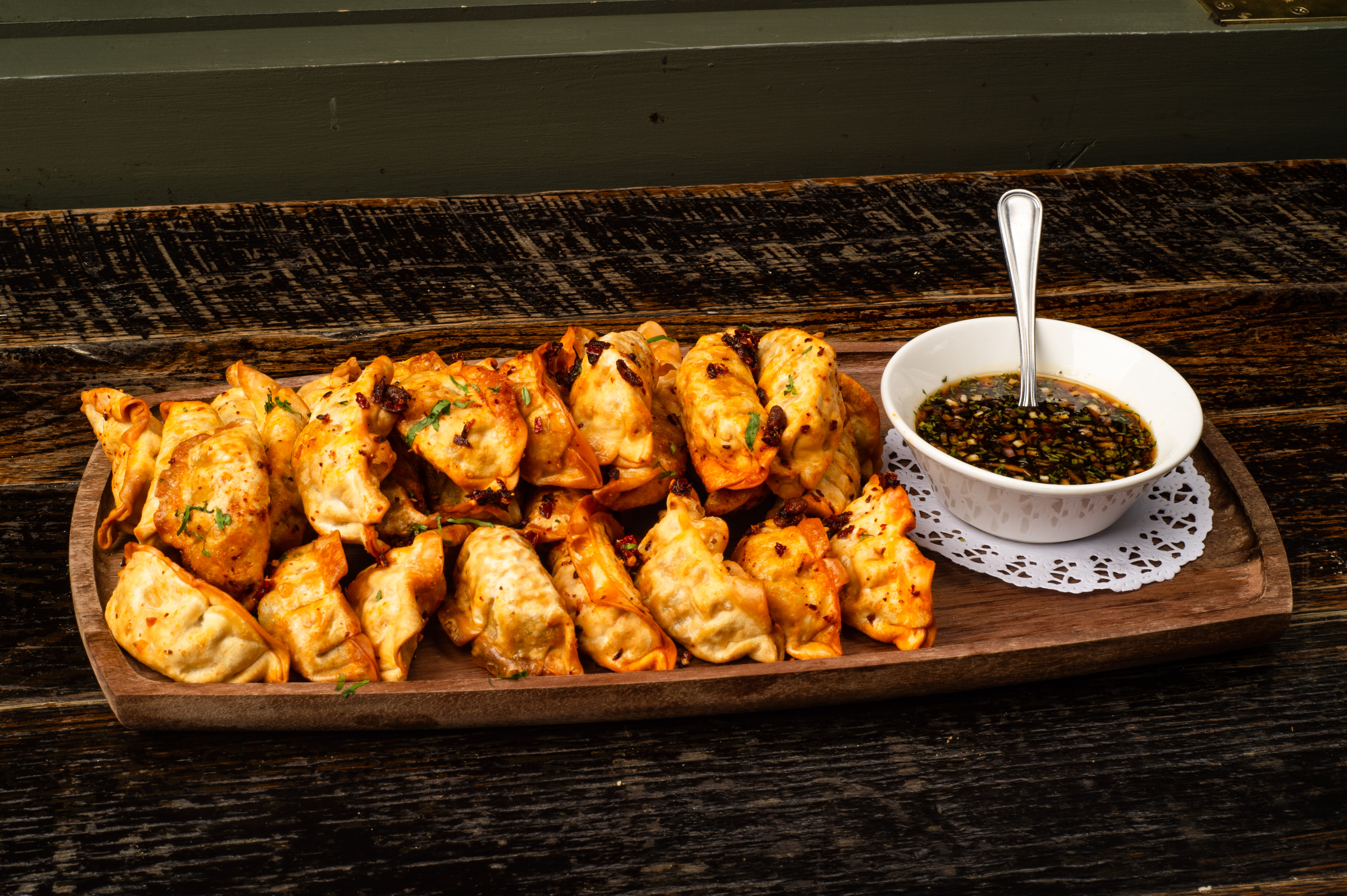 a plate of fried dumplings with sauce
