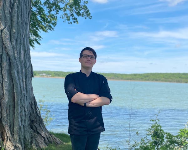 a man standing next to a body of water
