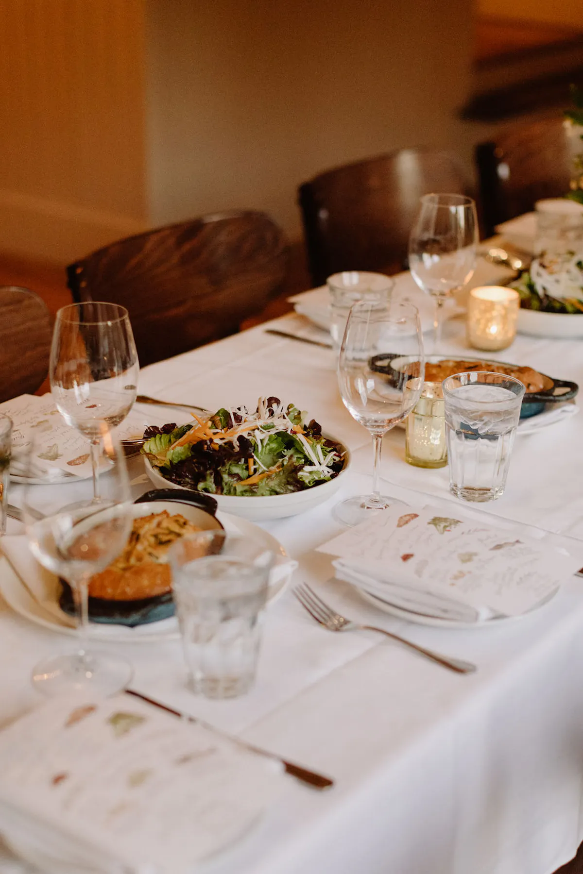 a plate of food and glasses of wine on a table