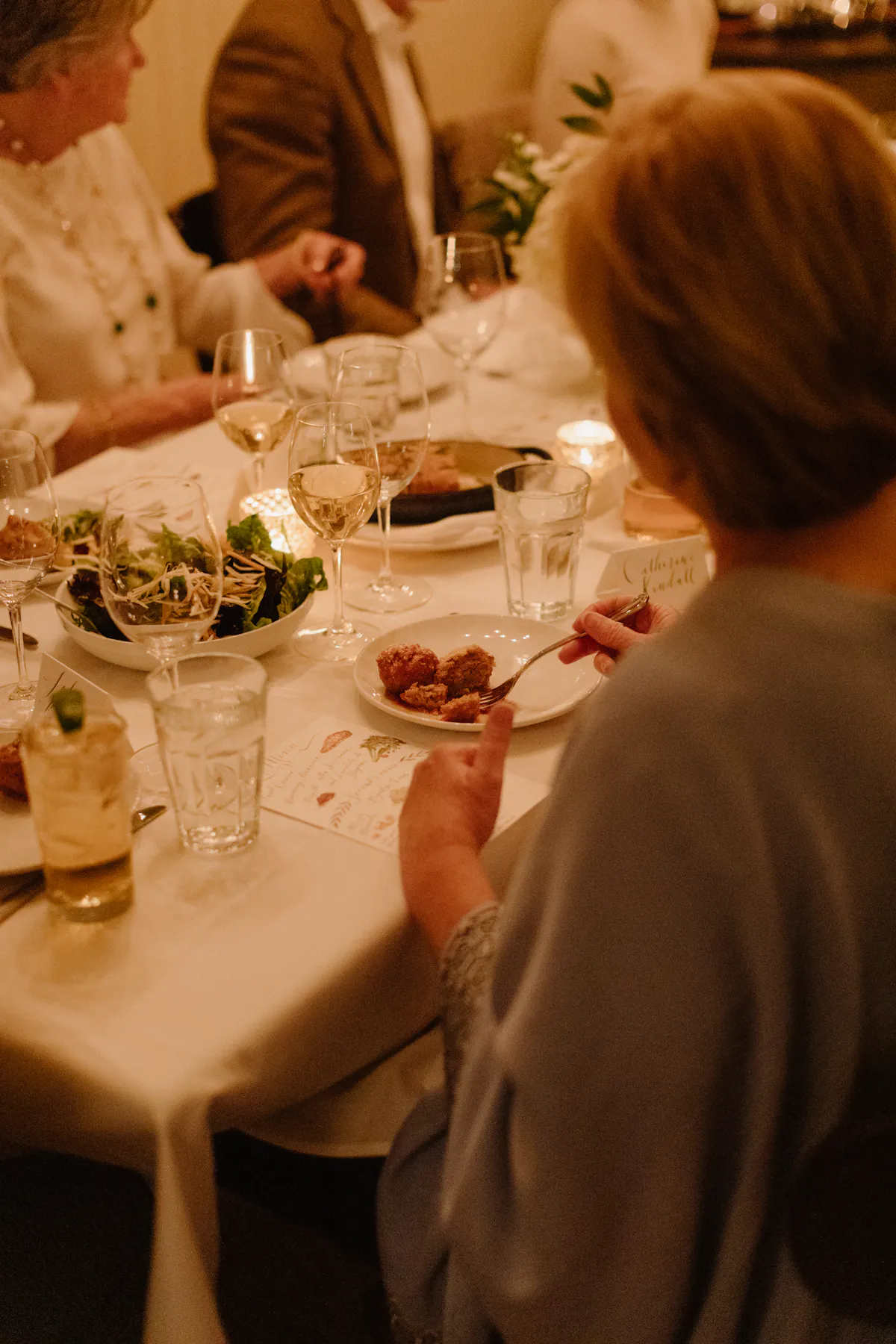 a group of people sitting at a dinner table