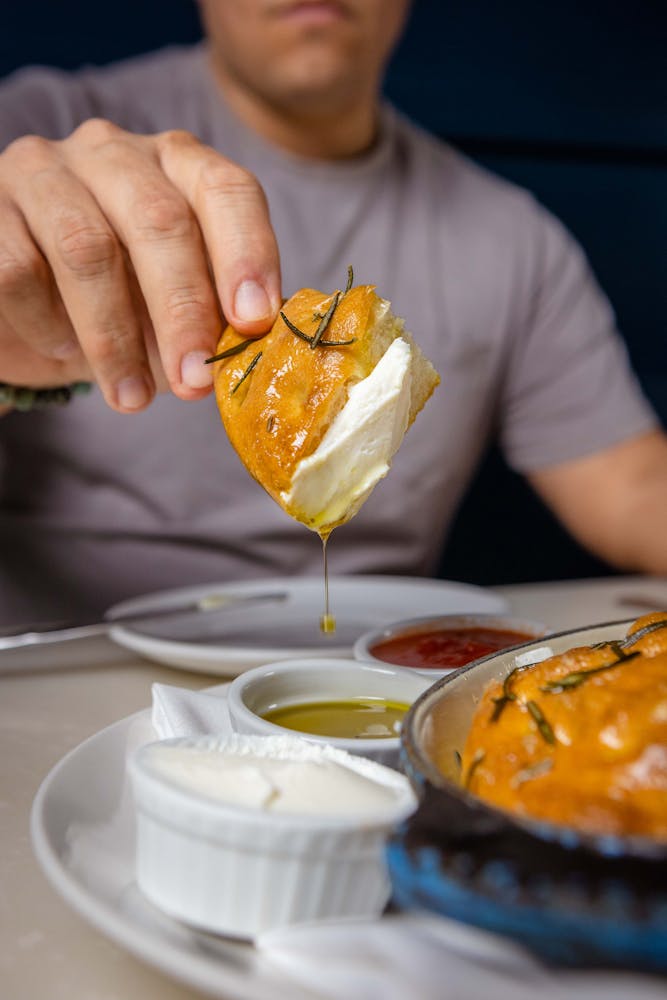 a person sitting at a table with a plate of food