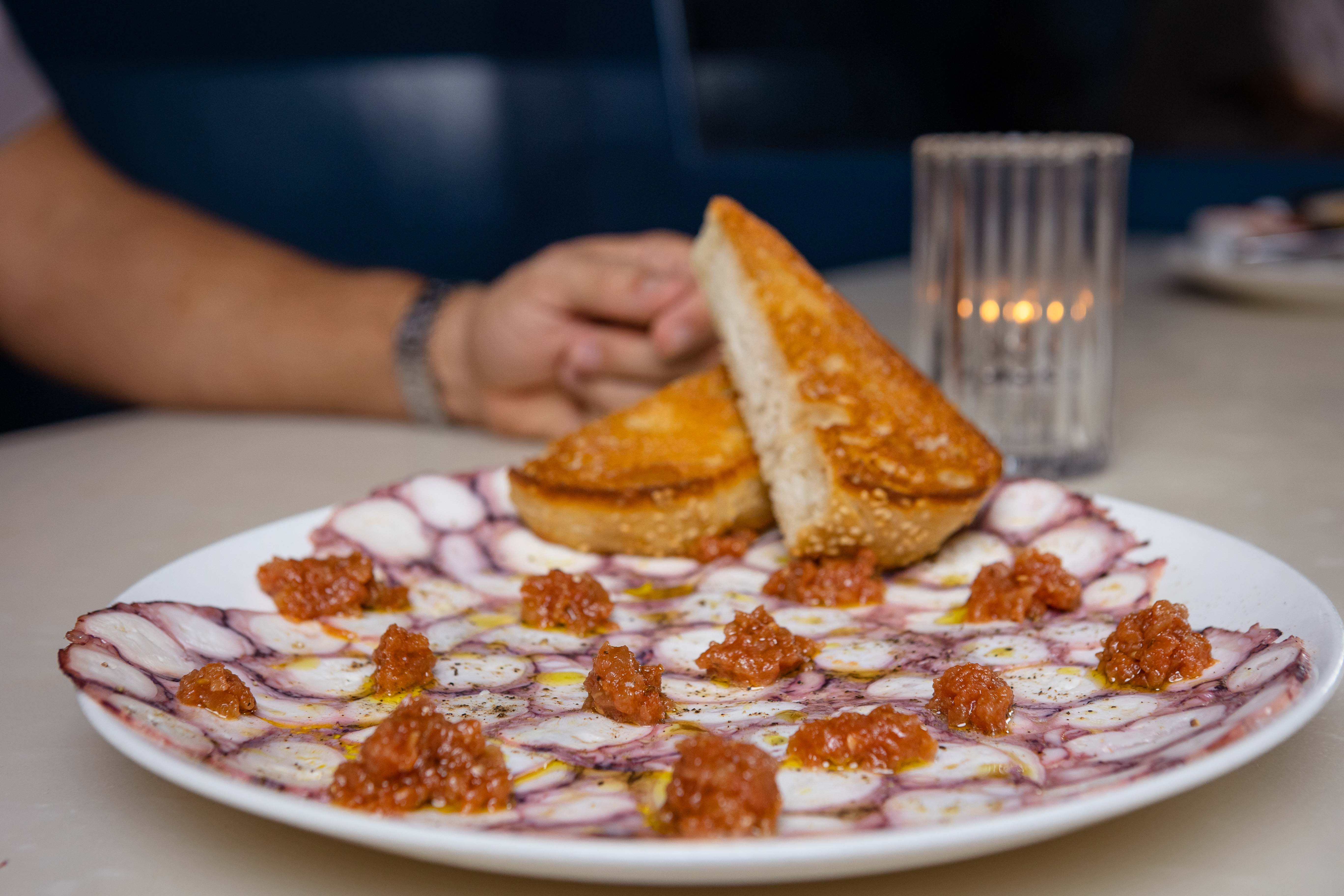 a pizza sitting on top of a plate of food on a table