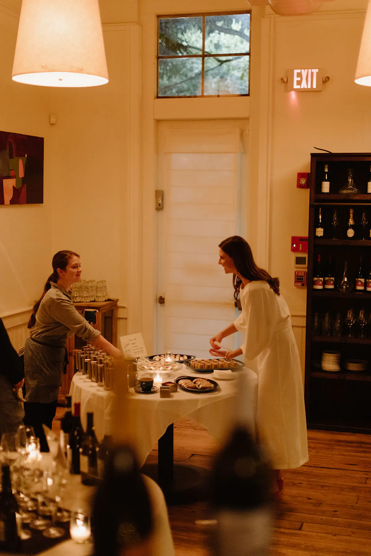 a group of people sitting at a table in front of a mirror