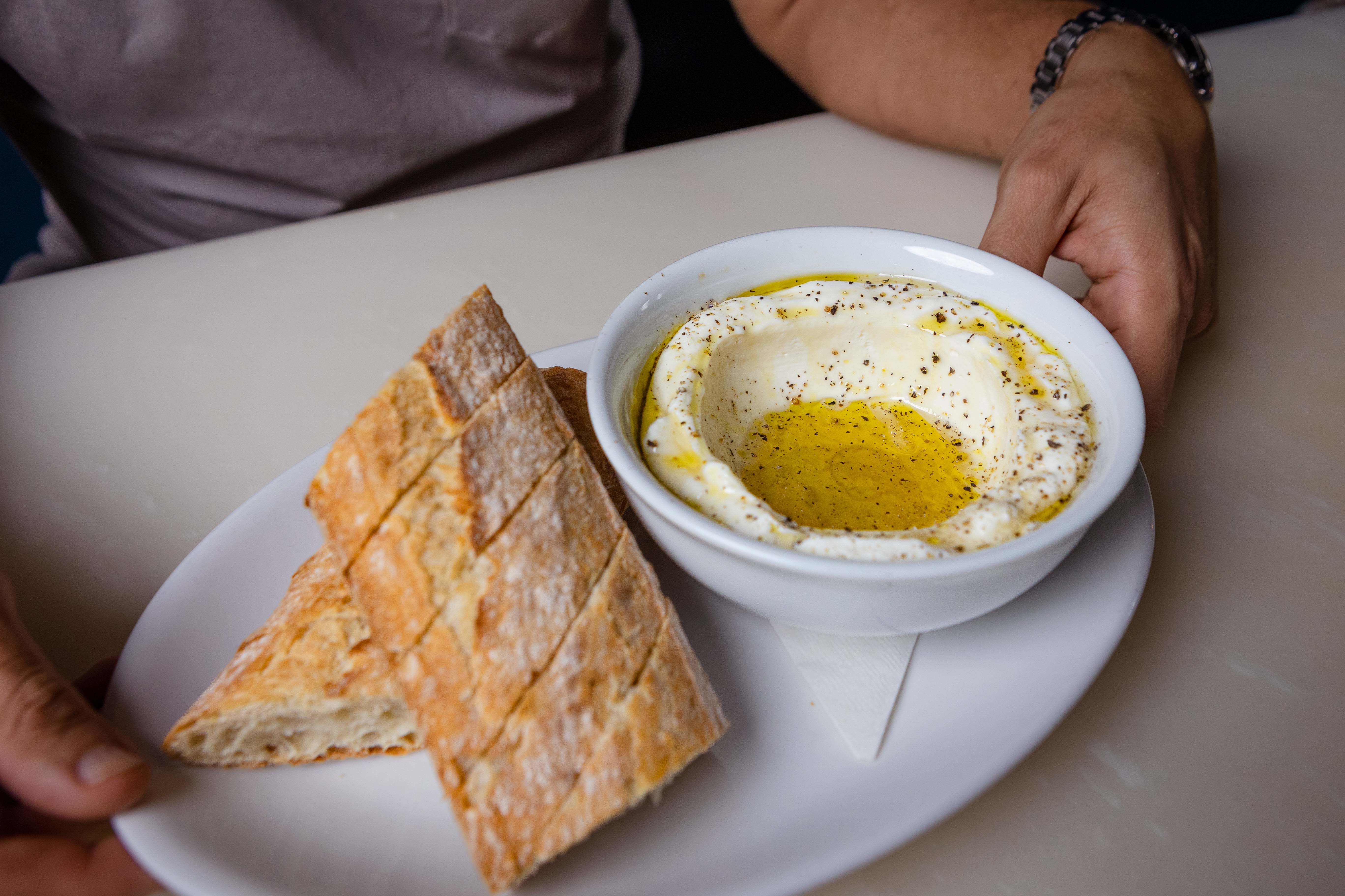 a person sitting at a table with a plate of food