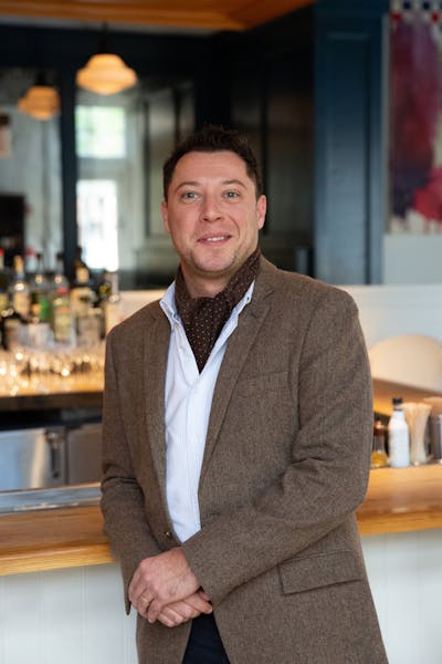 a man standing in front of a counter