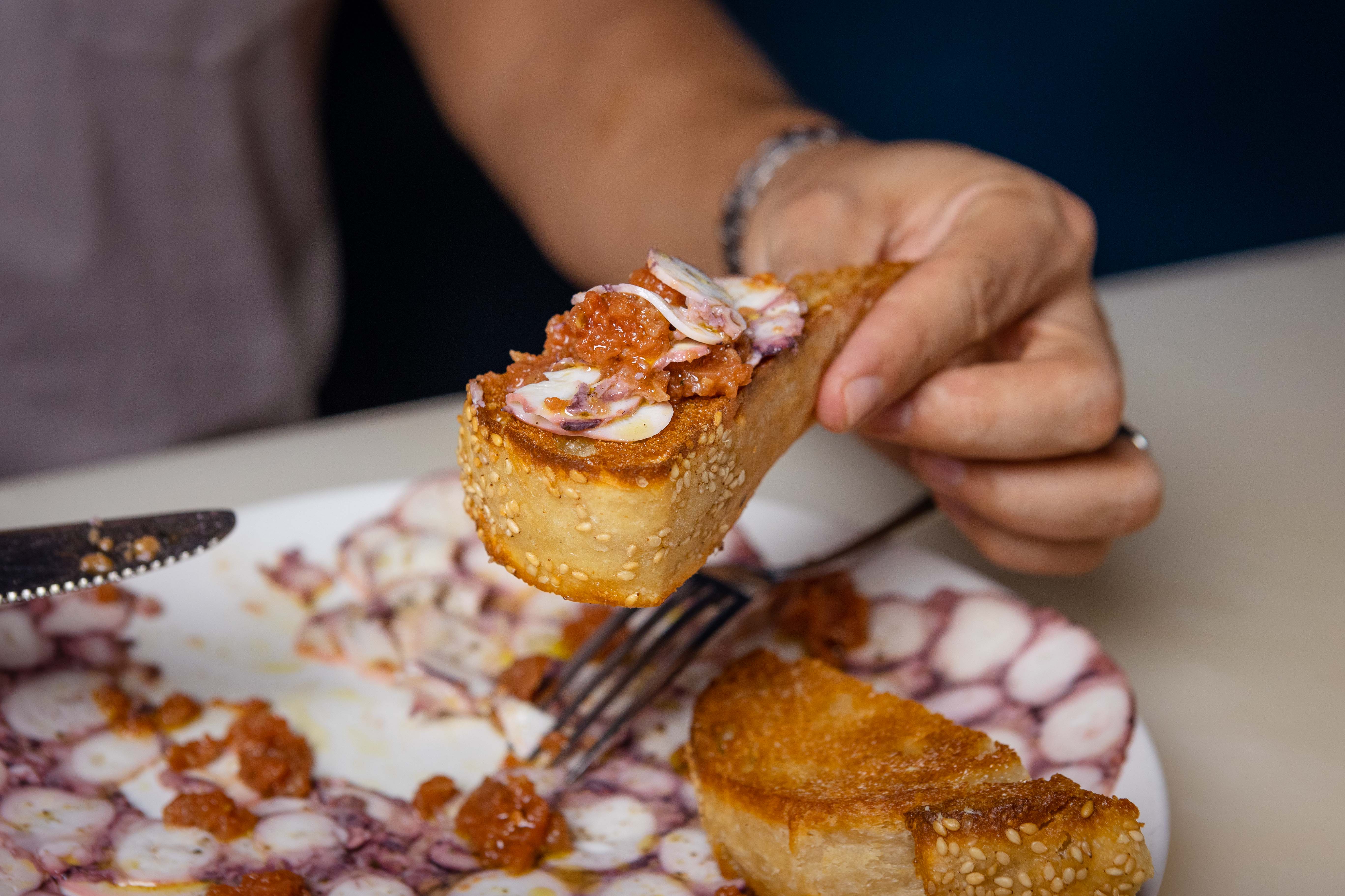 a close up of a person holding a piece of cake on a plate