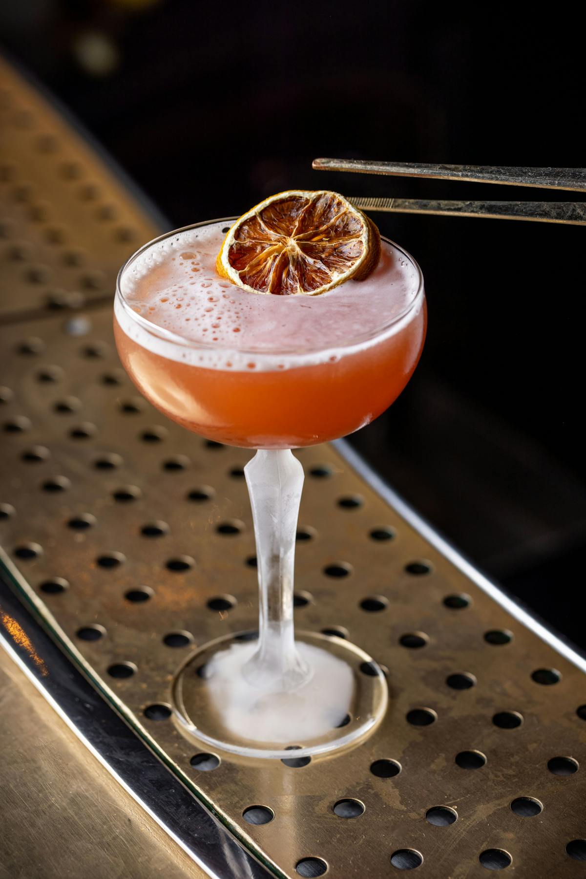 drink with a garnish being applied