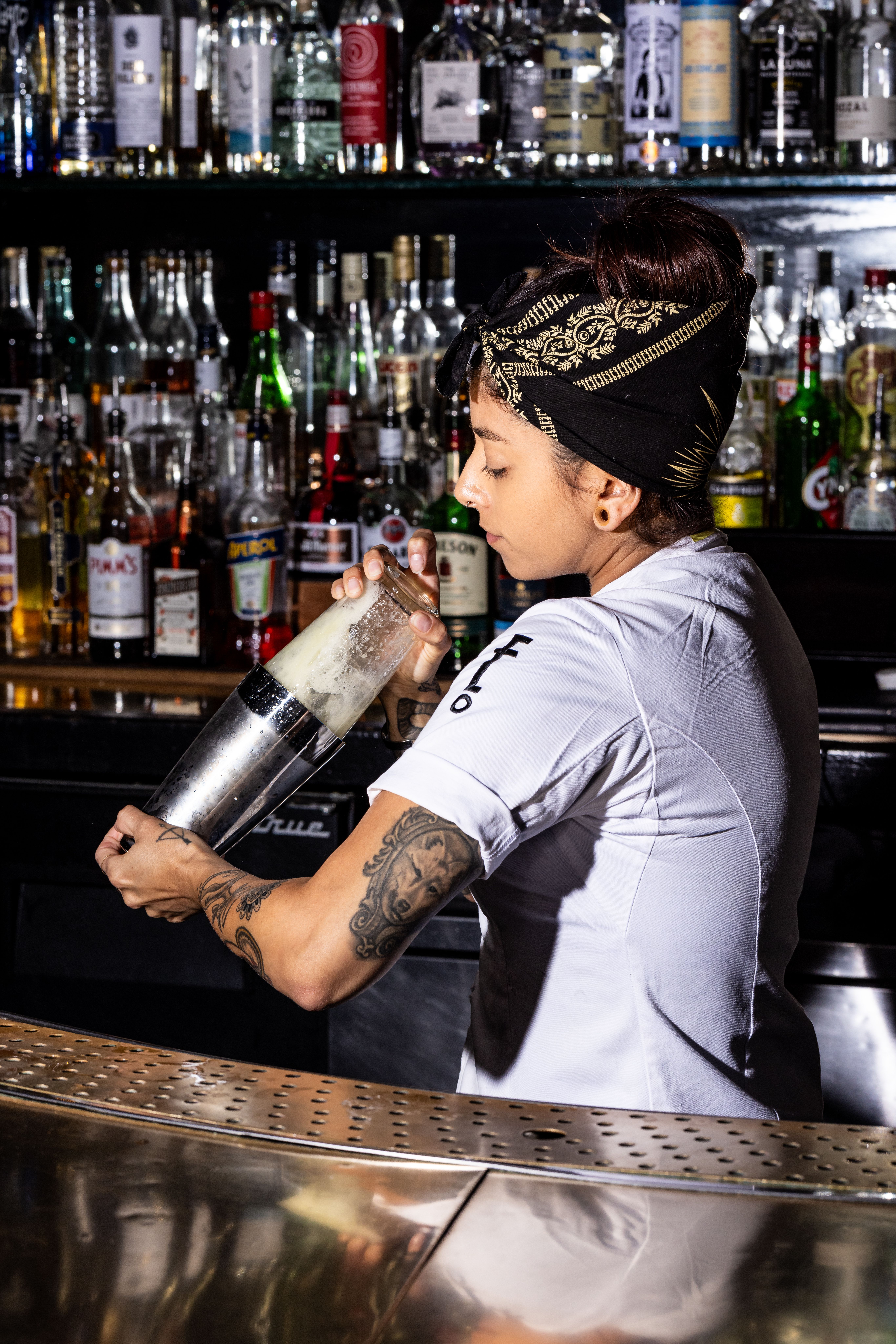 a man standing next to a bottle of wine