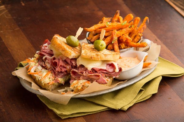 a sandwich sitting on top of a wooden table