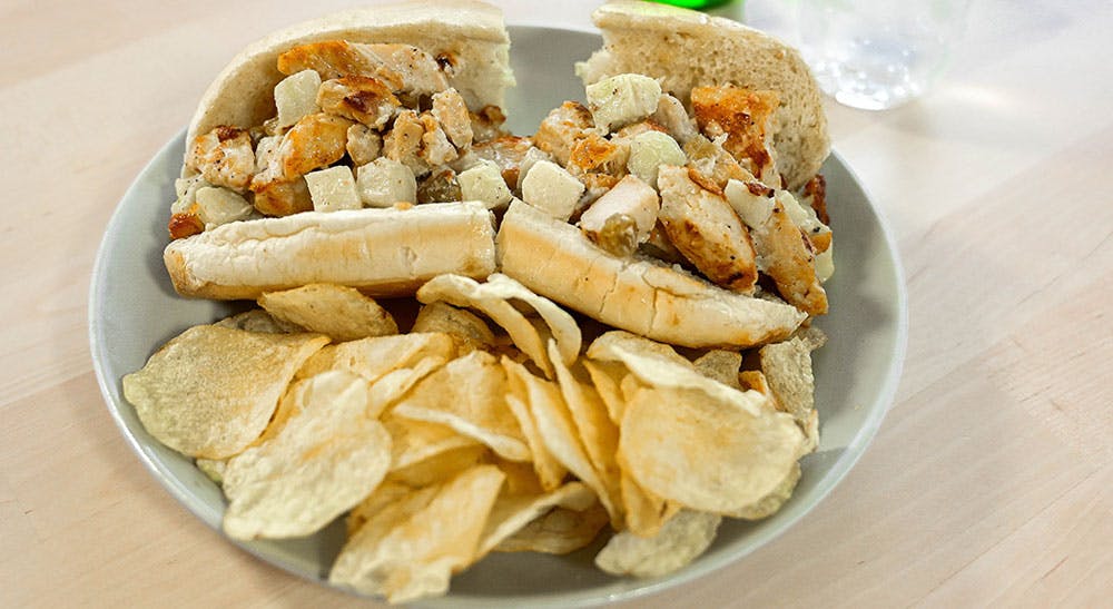 a sandwich sitting on top of a wooden table