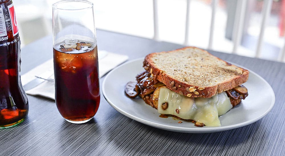 a plate of food and a glass of beer on a table