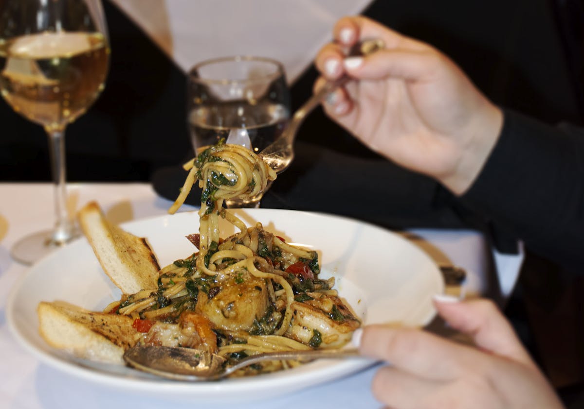 a plate of food and a glass of wine