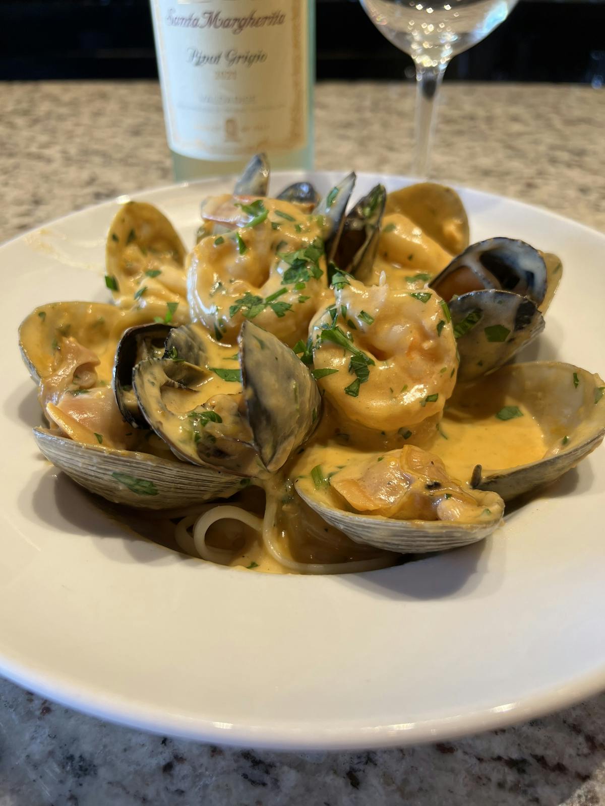 a plate of food and a glass of wine