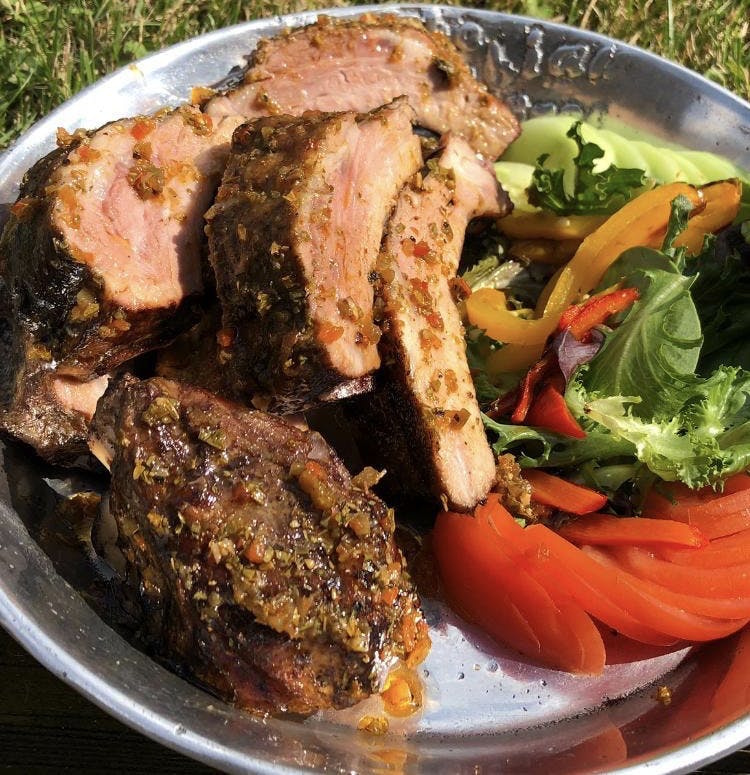 a plate topped with vegetables and grilled meat