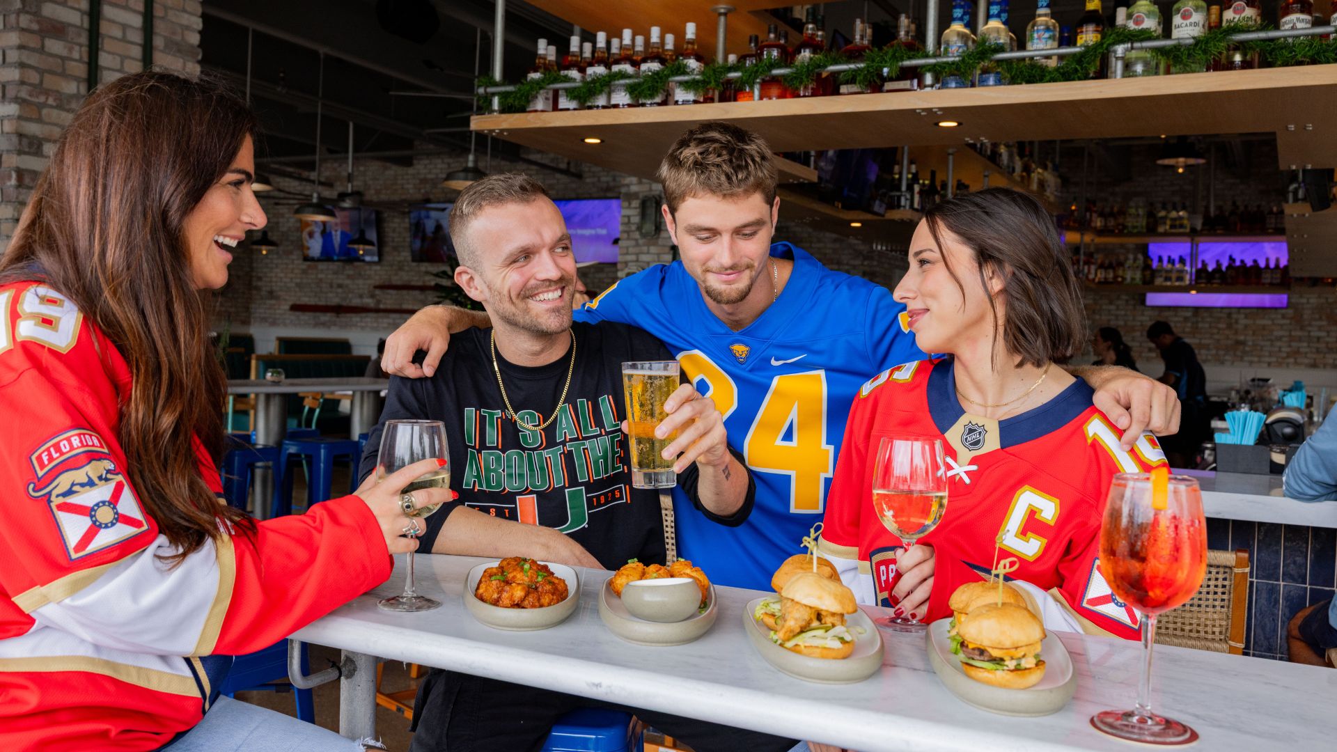 a group of people sitting at a table with food