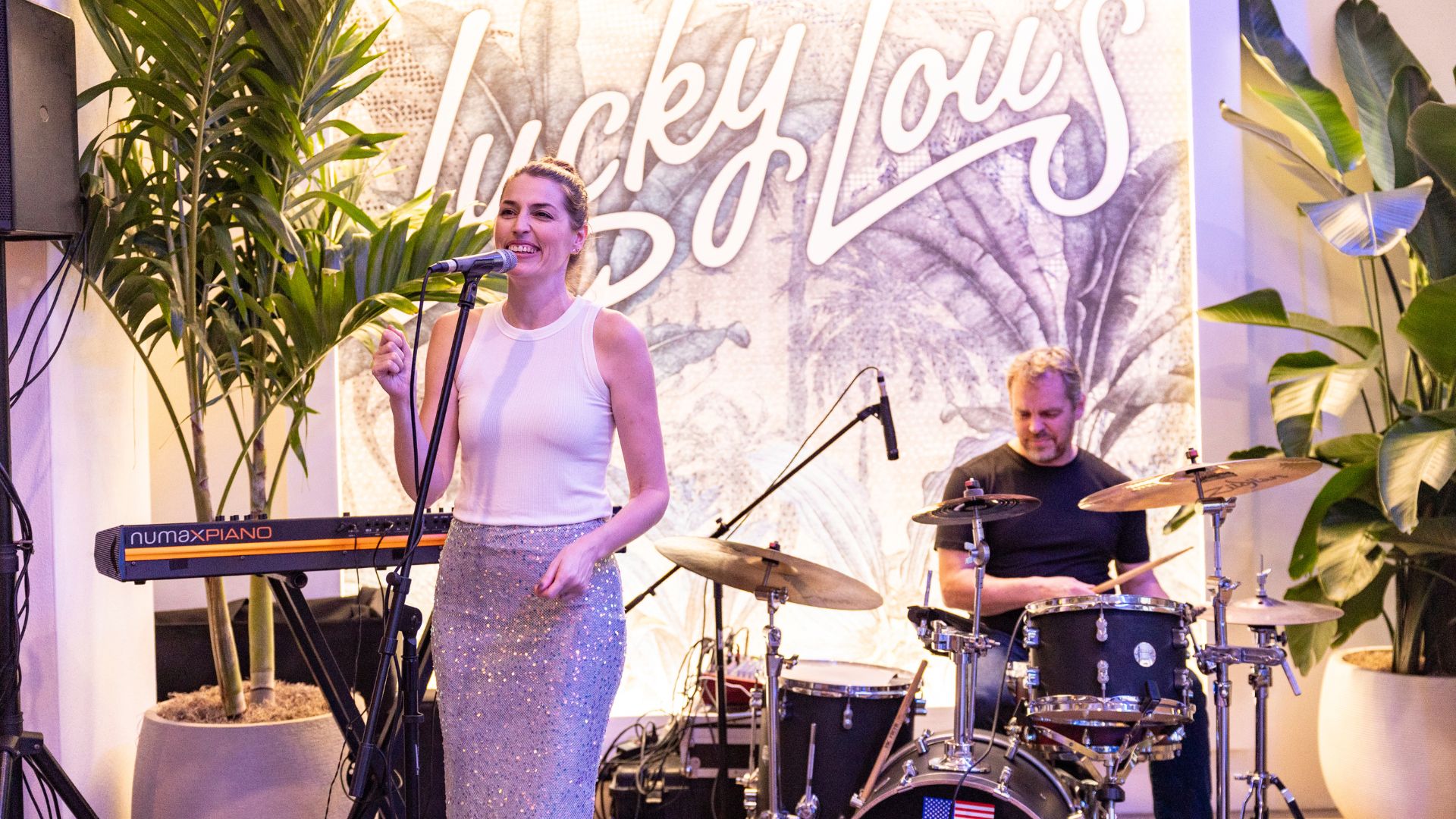 Band singing and playing the drums at Lucky Lou's