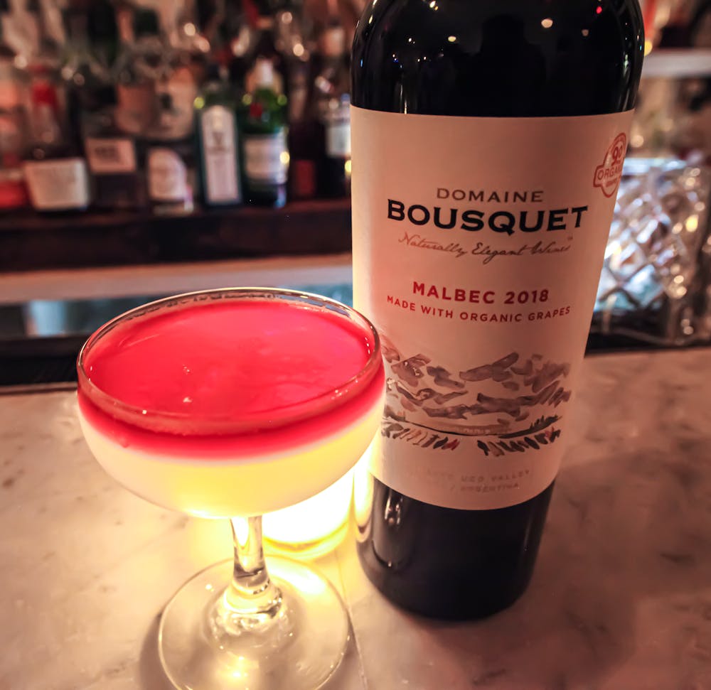 a close up of a bottle and a glass of wine