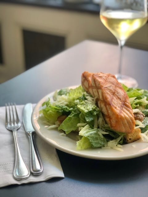 a plate of food and a glass of wine