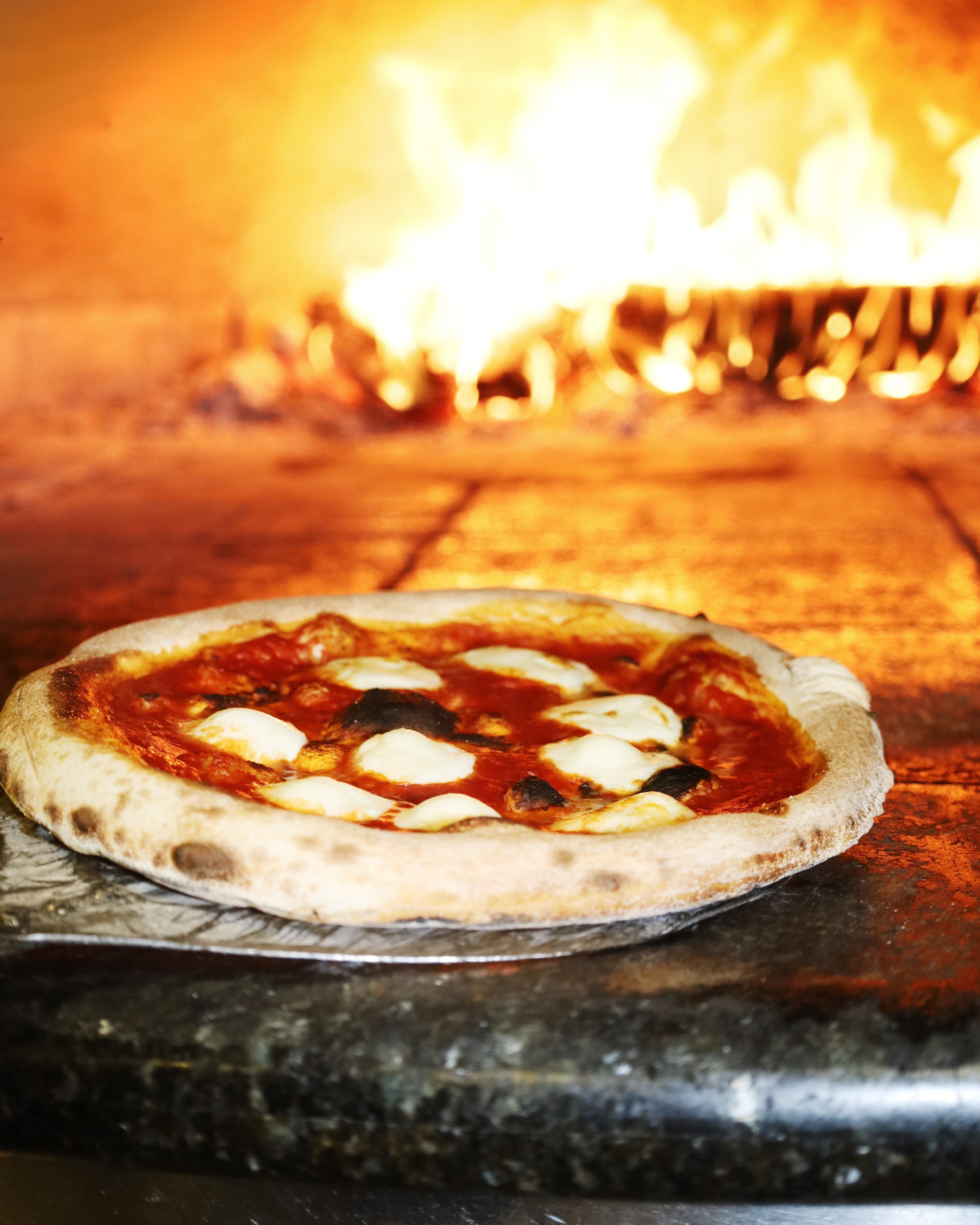 a pizza cooking in an oven