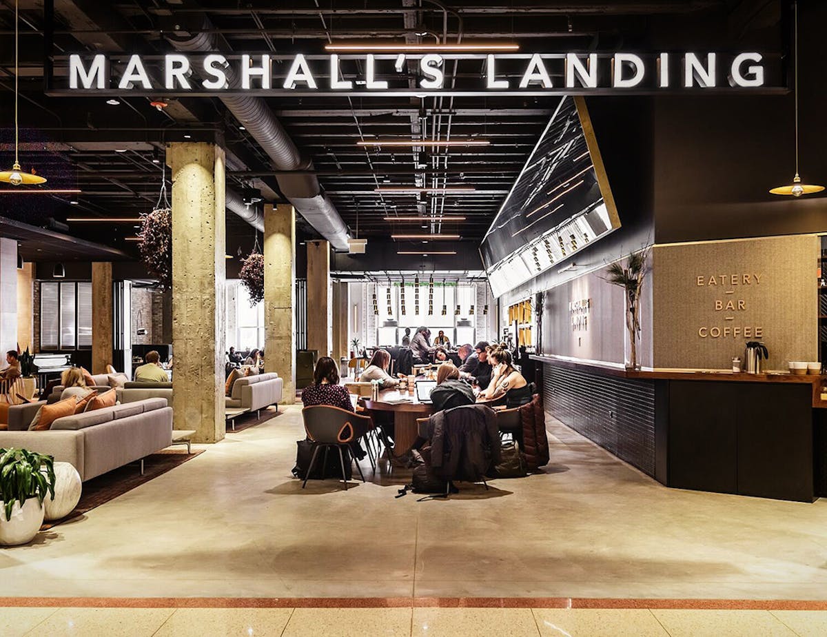 a group of people sitting at a table in front of a store