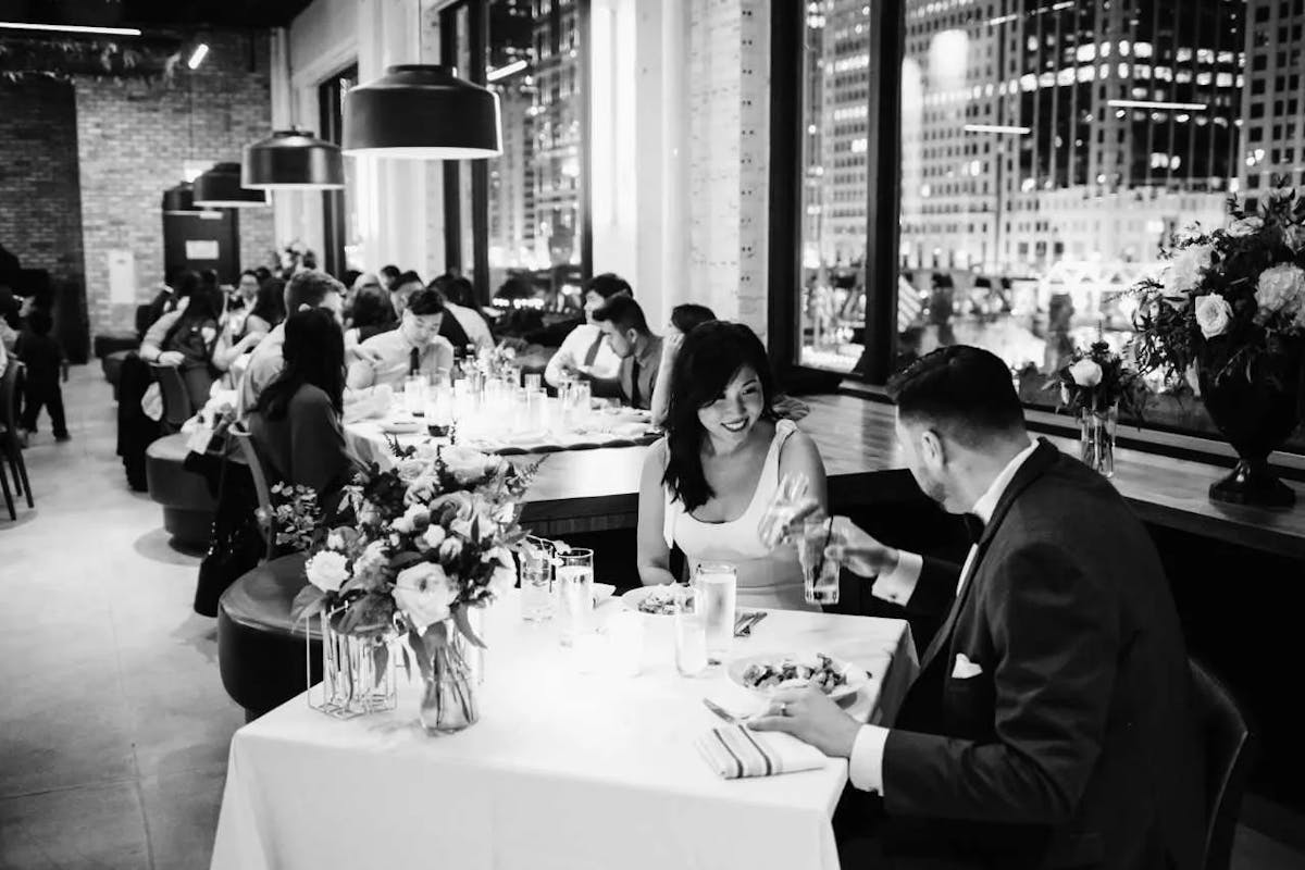 a group of people sitting at a table in a restaurant