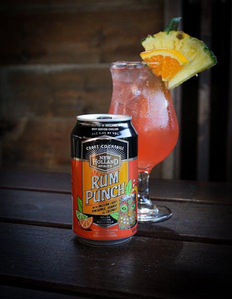 a can of juice with a glass cup