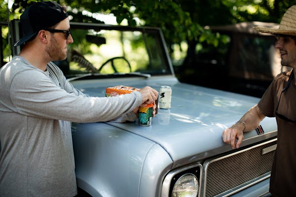 a man standing in front of a car
