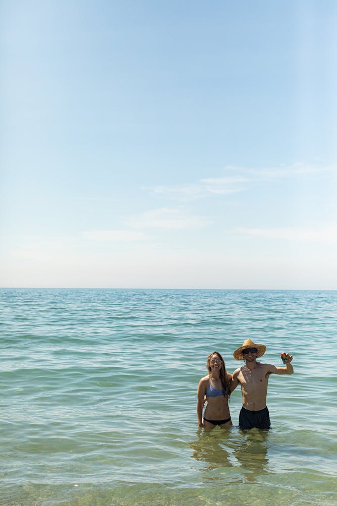 a couple of people that are standing in a body of water