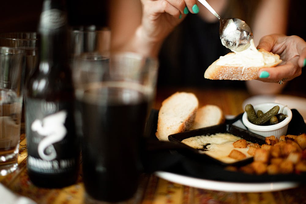 a person sitting at a table with a plate of food