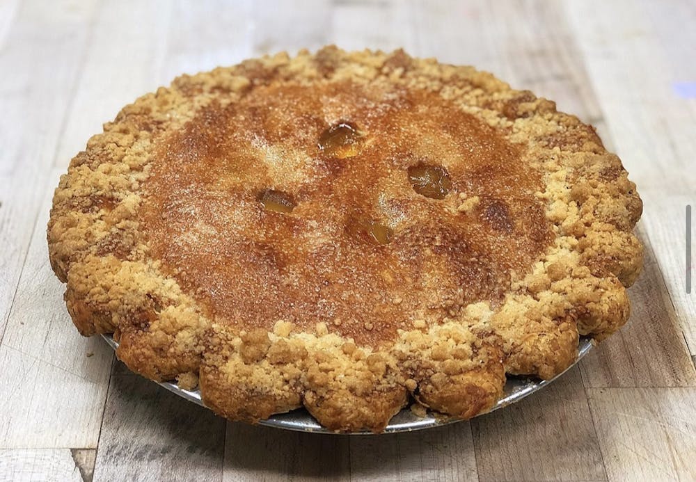 a piece of bread on a cutting board with a cake