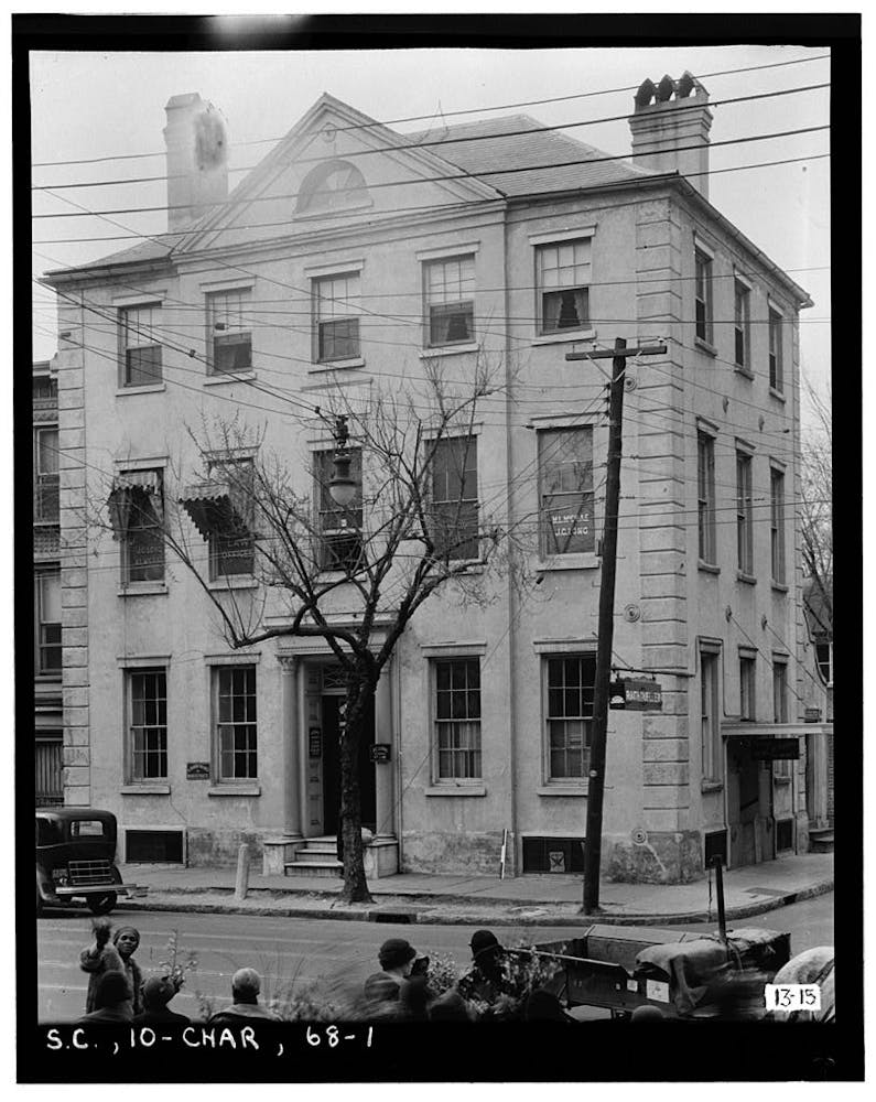 a group of people in front of a brick building