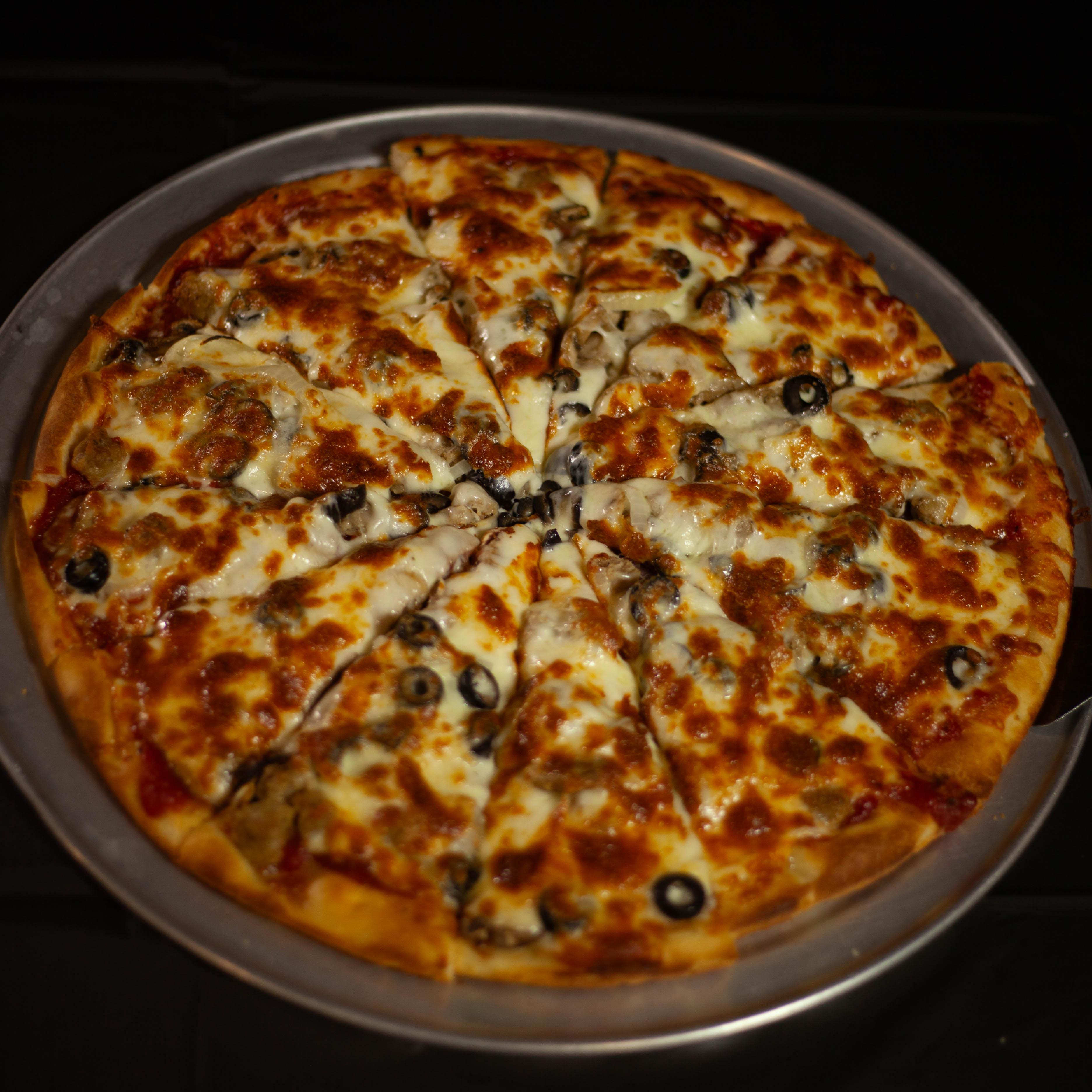 a pizza sitting on top of a pan