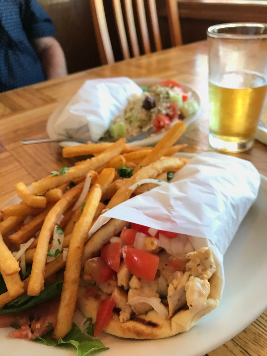 a plate of food with a sandwich and fries on a table