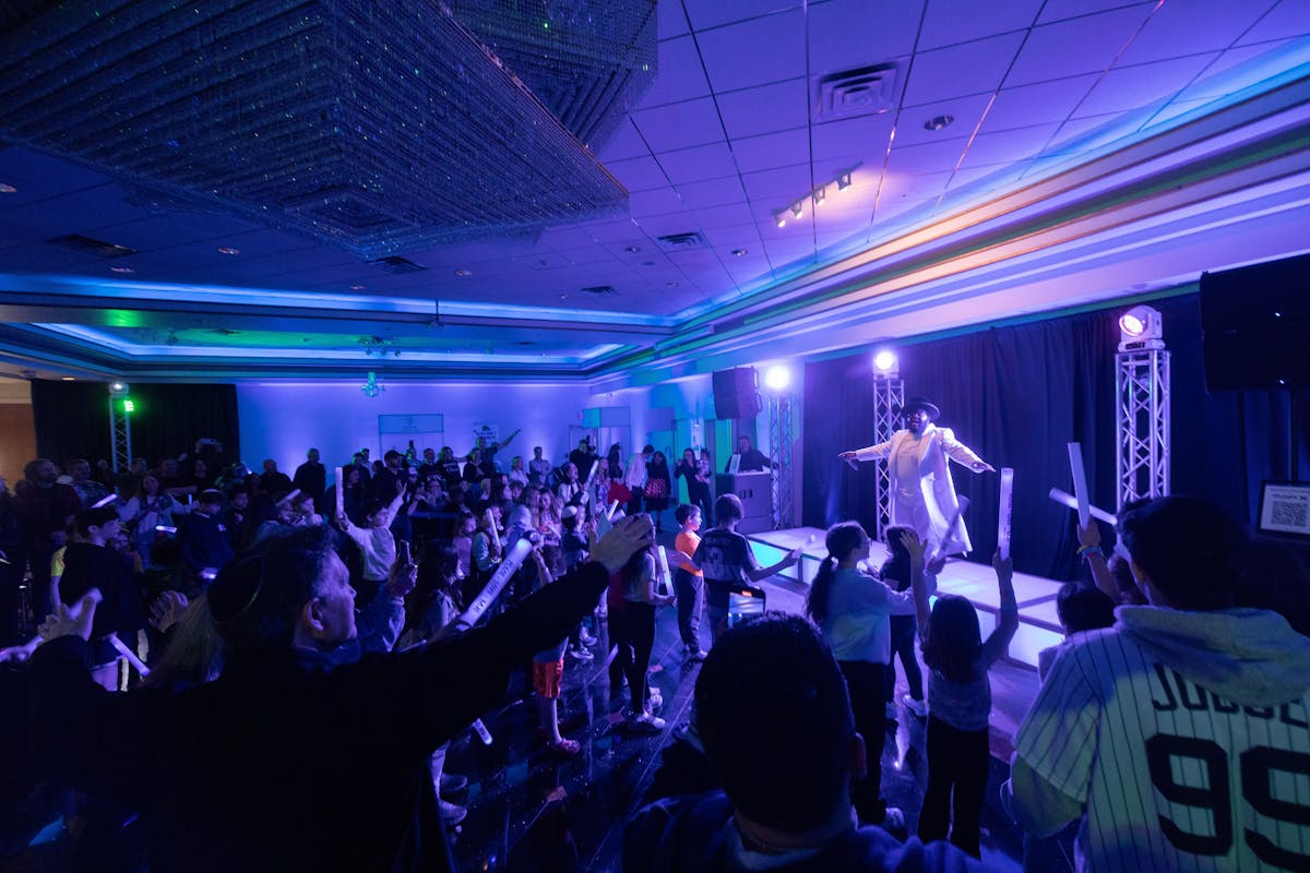 a group of people on a stage in front of a crowd