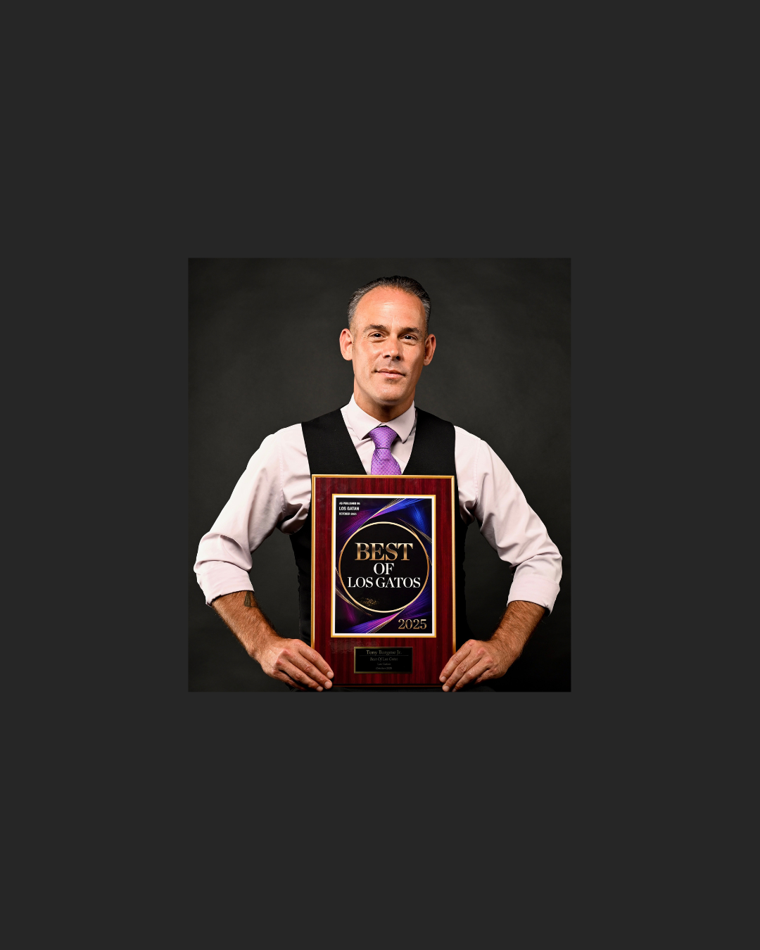 a man holding a plaque