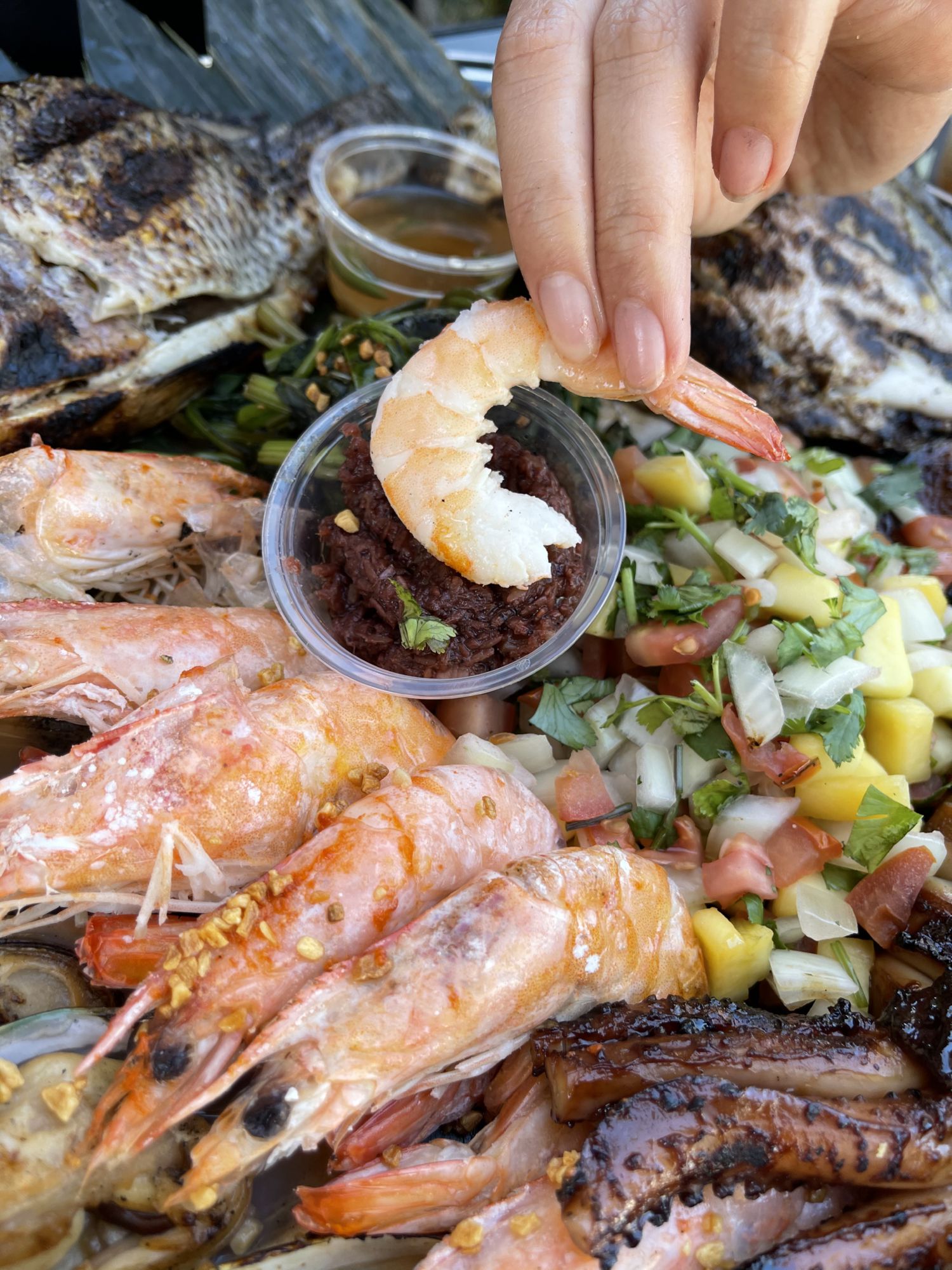 view of a shrimp being dipped in sauce