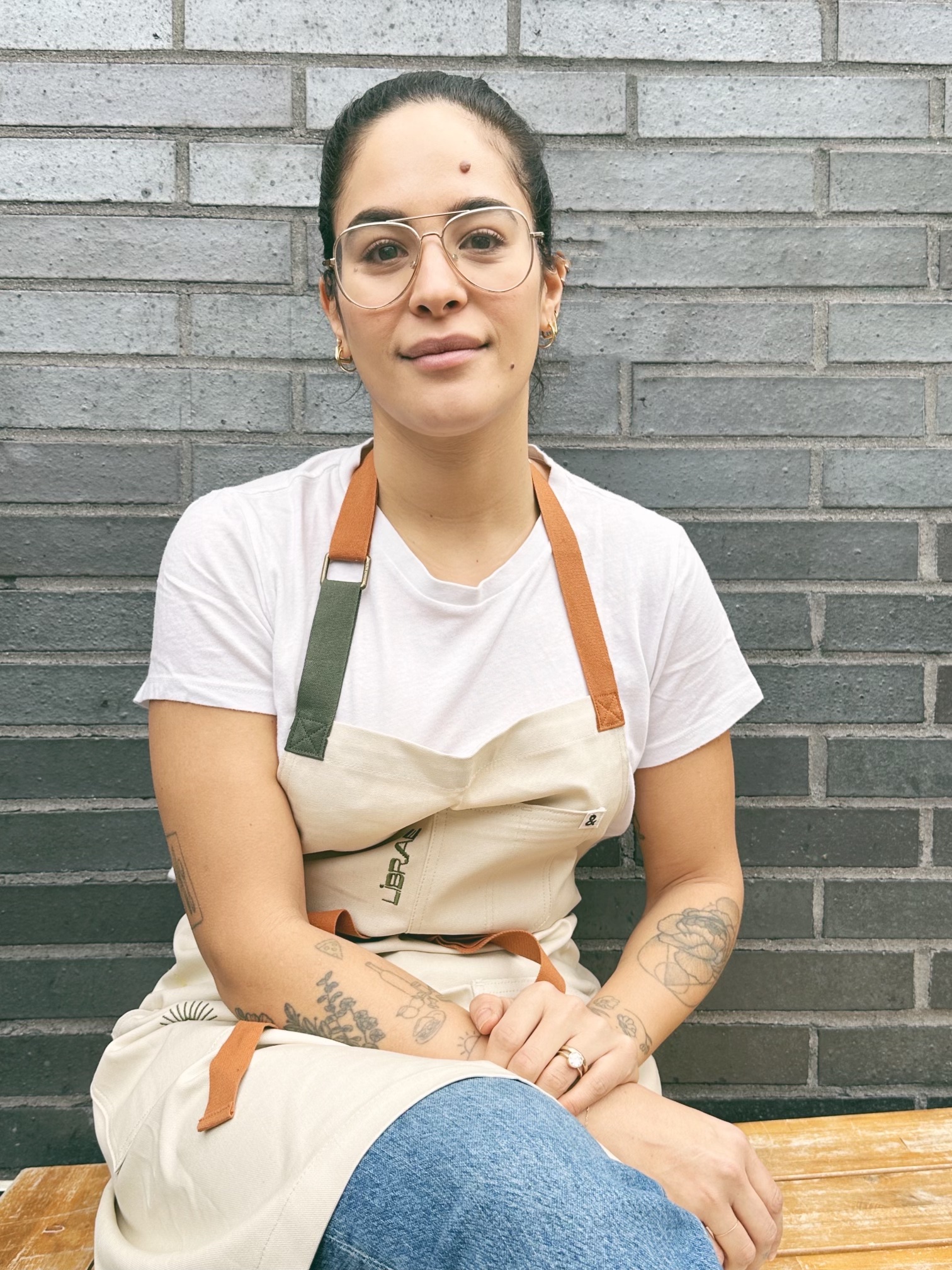 a person sitting on a bench posing for the camera