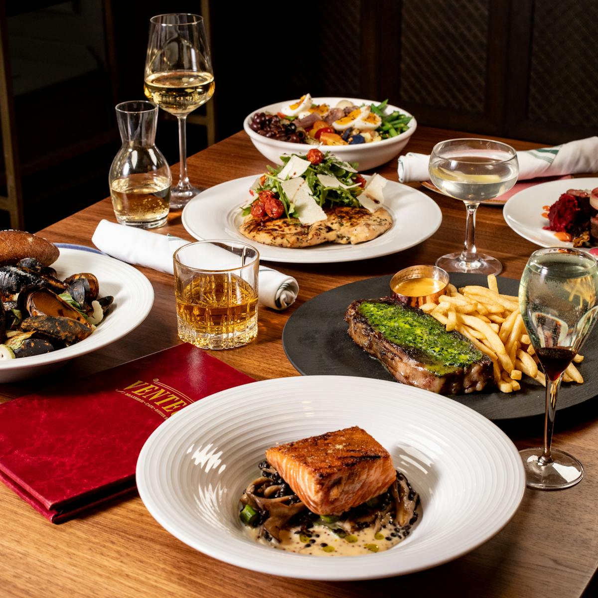 a group of people sitting at a table with a plate of food