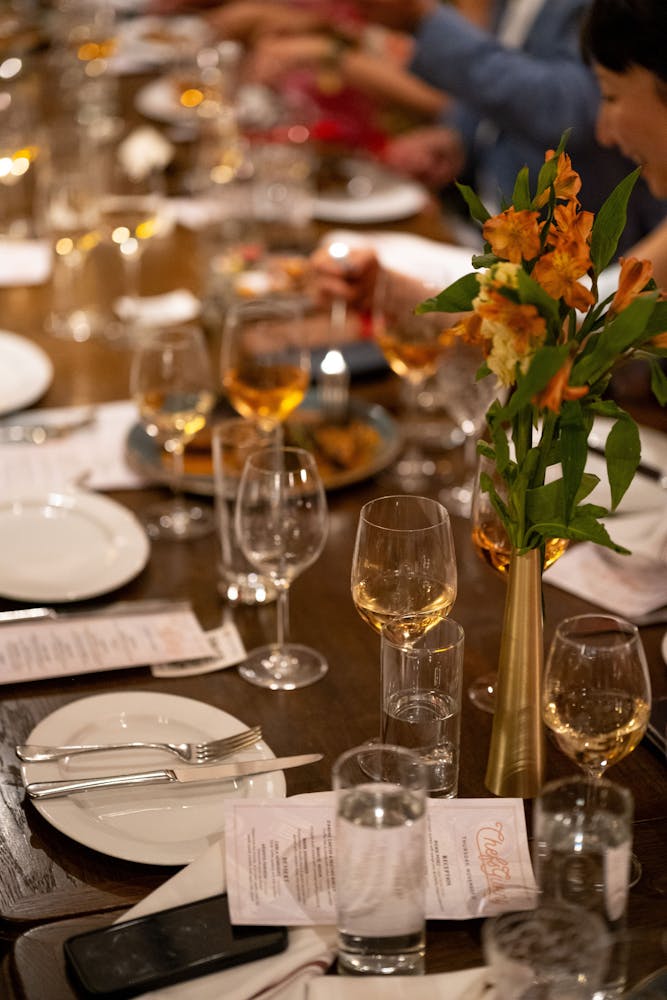 a group of people sitting at a table with wine glasses