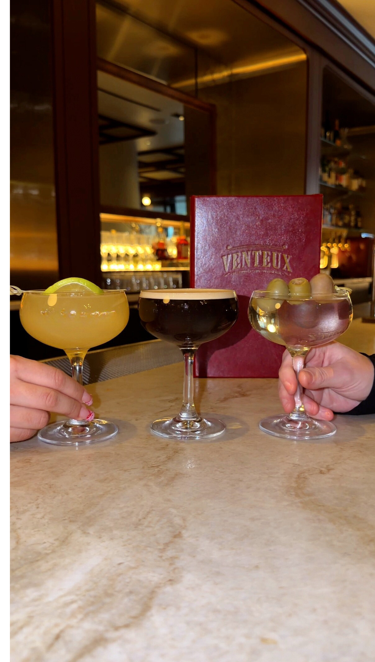 a group of glasses of different colored drinks