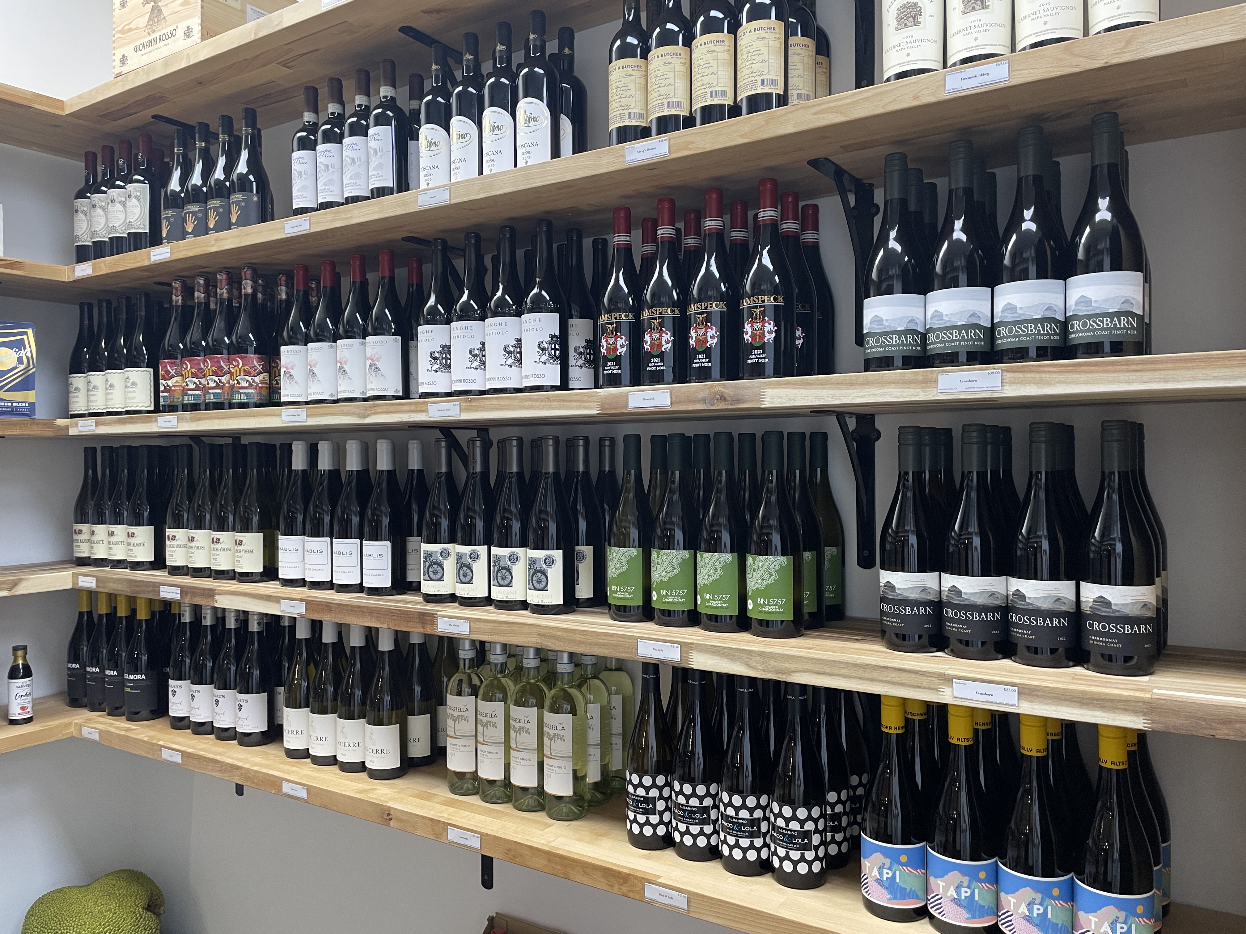 a store shelf filled with wine glasses