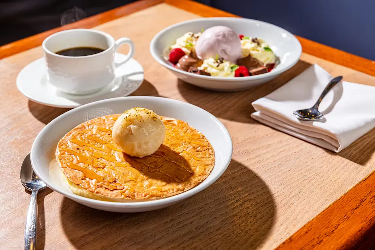 a plate of food and a cup of coffee on a table
