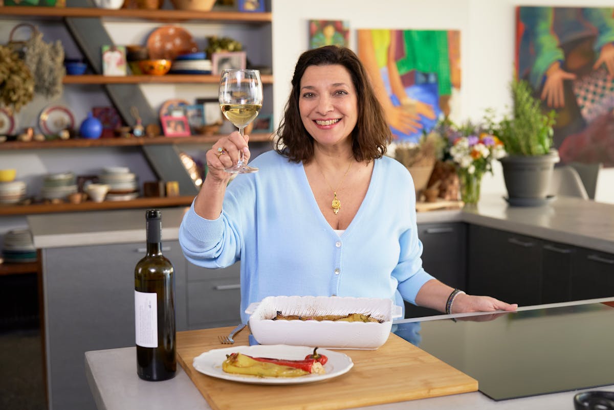 a woman sitting at a table with food