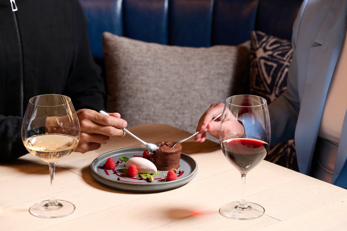 plate of dessert on a table shared by two people