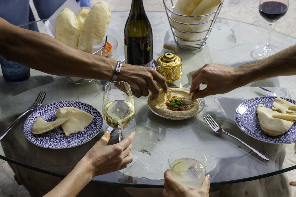a group of people sitting at a table with wine glasses